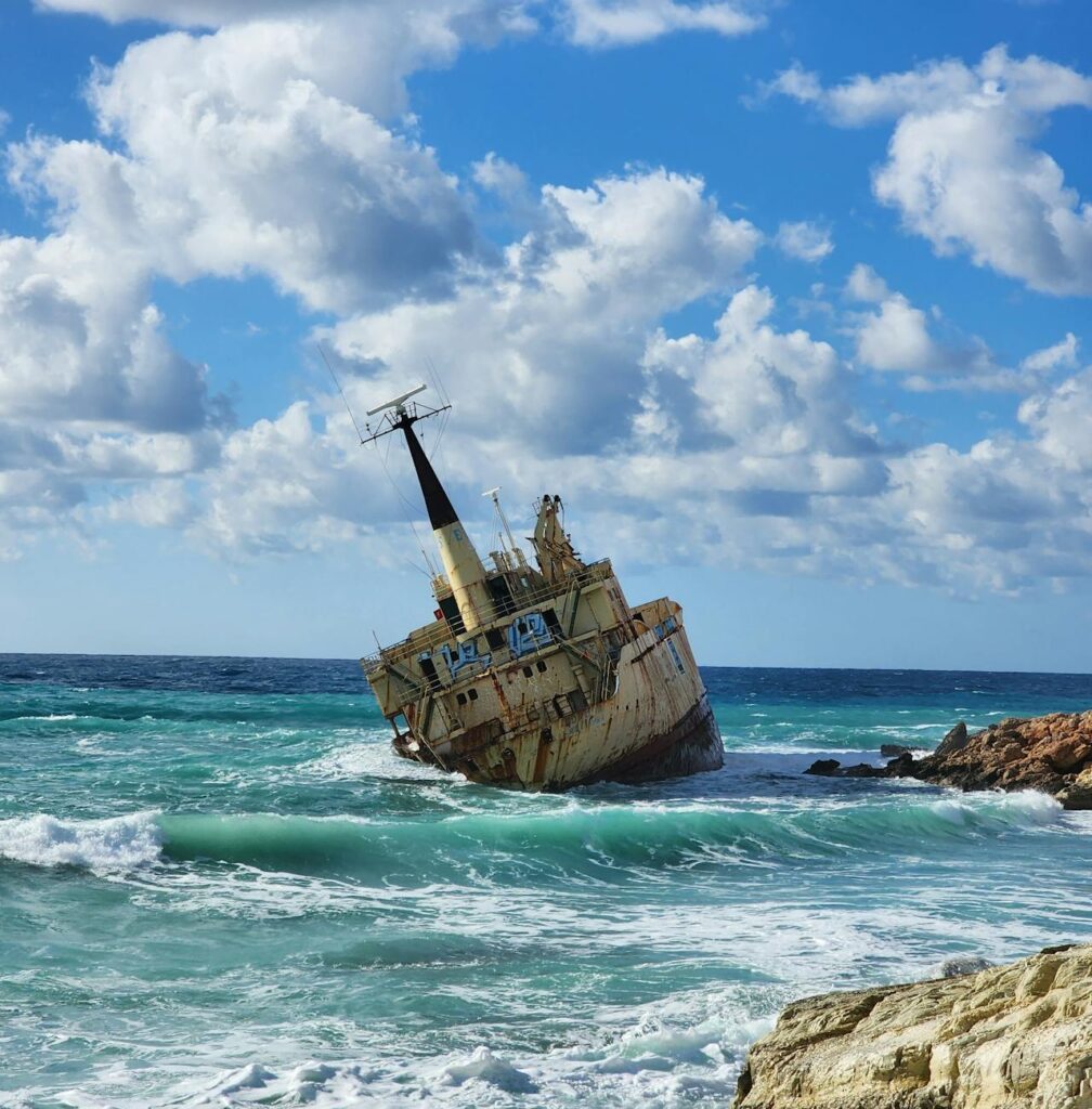 shipwrecked vessel on rocky ocean shore