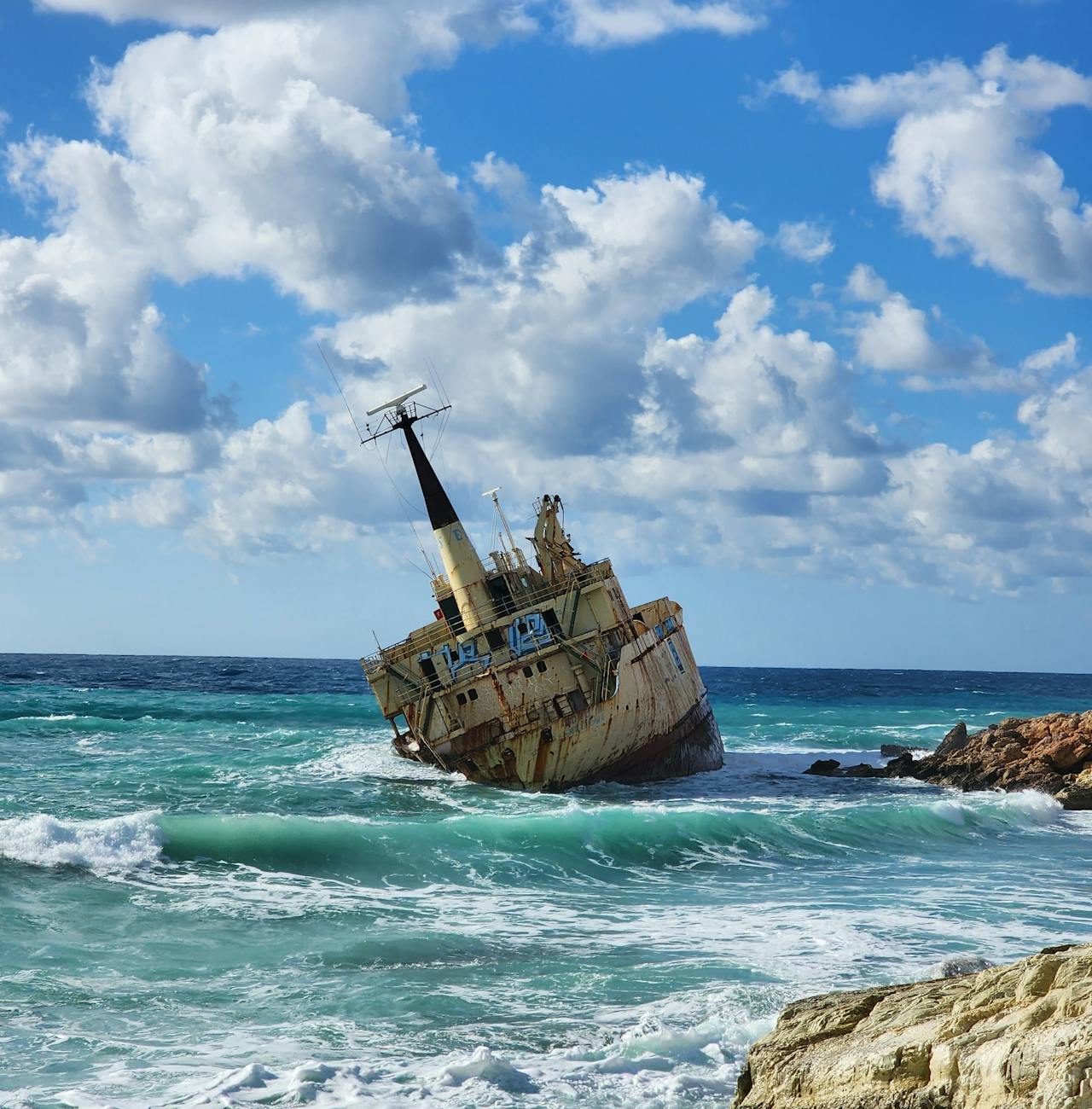 shipwrecked vessel on rocky ocean shore