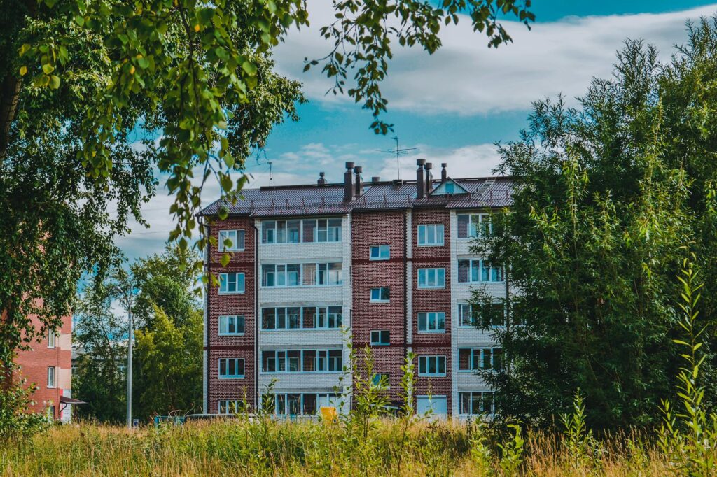 brick apartment building in lush greenery
